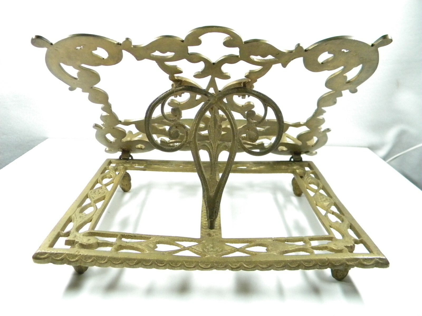 Cast brass book stand.