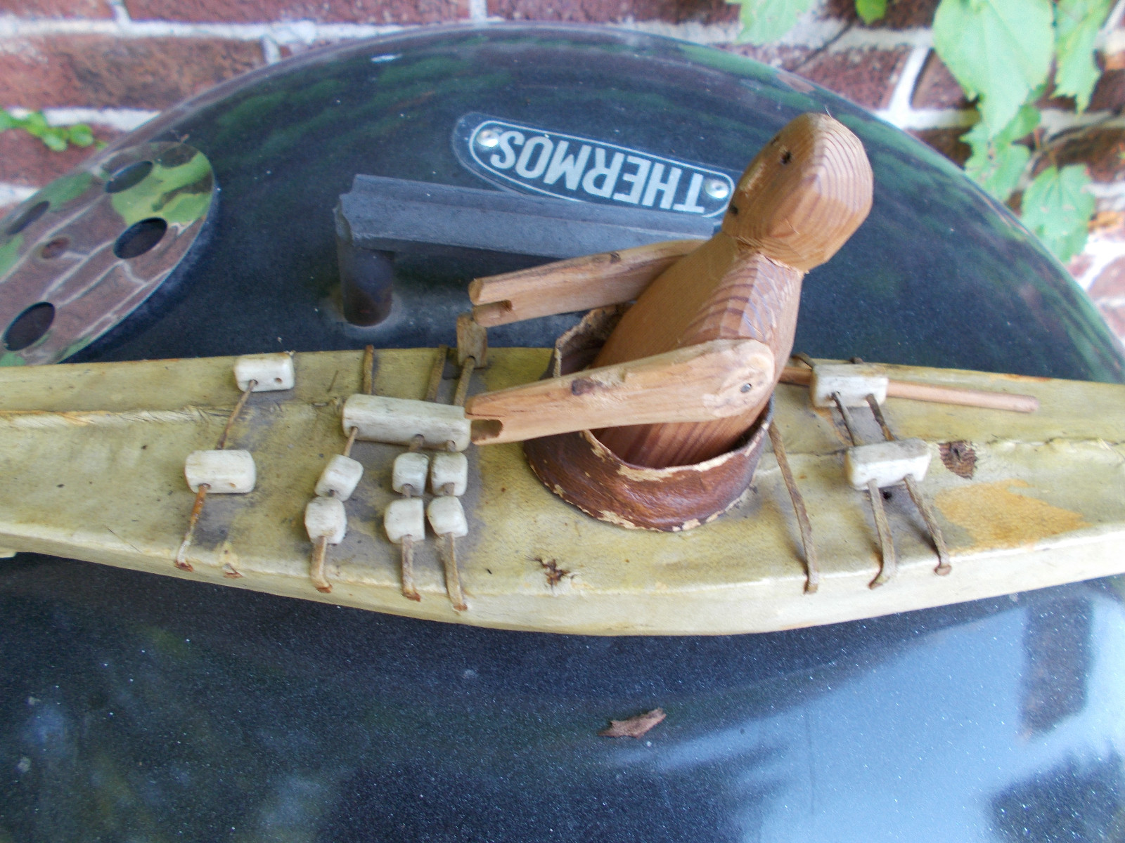 VERY OLD ESKIMO FOLK ART KAYAK WITH DOLL-SEAL SKIN AND WOOD 27.5 INCHES