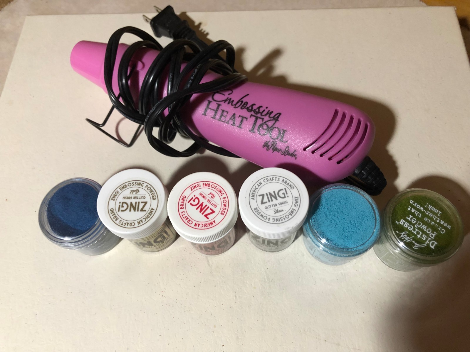 Embossing heat tool with 6 embossing powders.