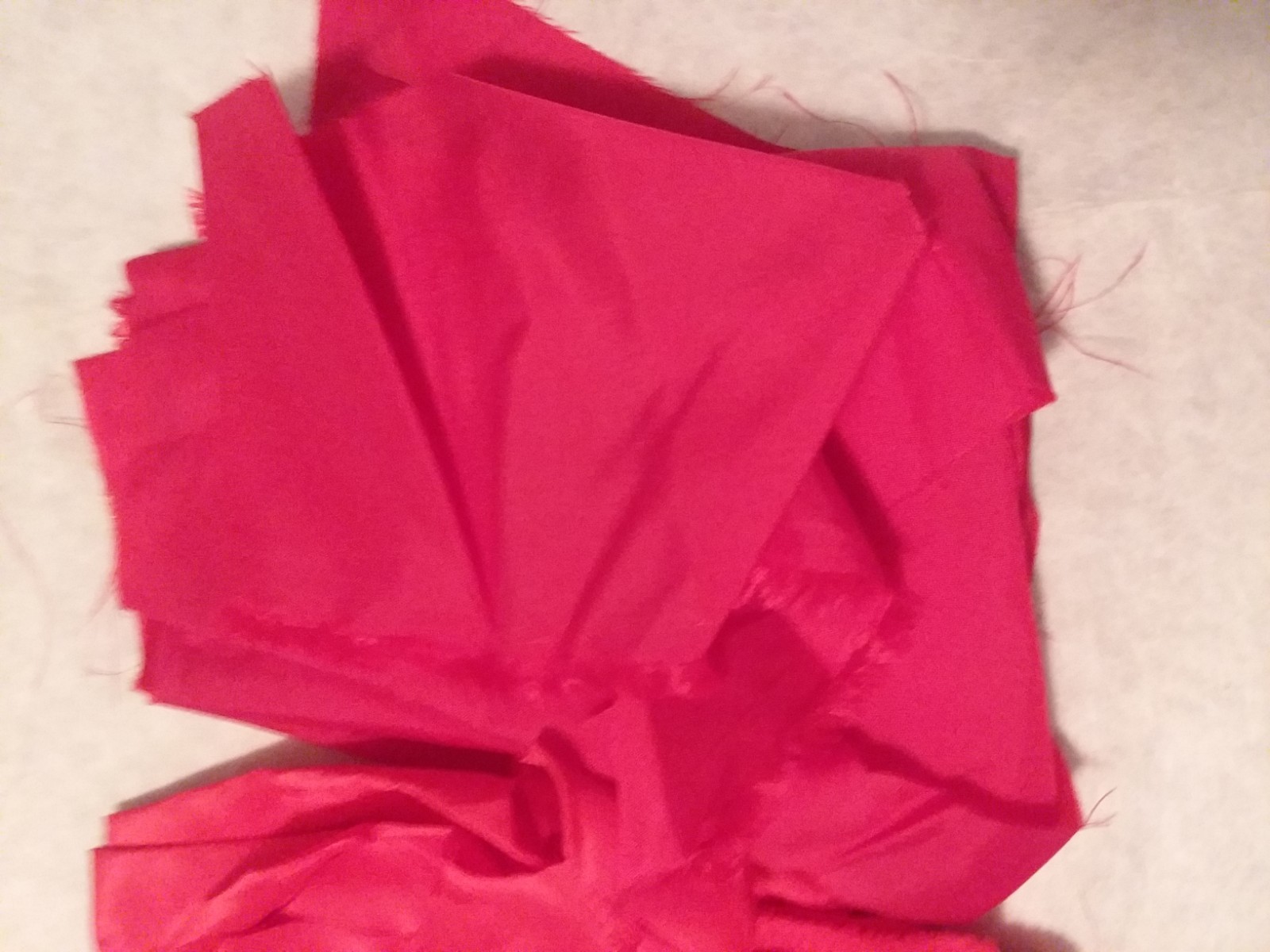 RED POLYESTER MATERIAL, SOLID MATERIAL AND PIECES, APPROXIMATELY 1/3 YARD