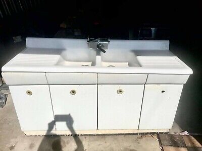 antique porcelain farm sink white with unique faucet.