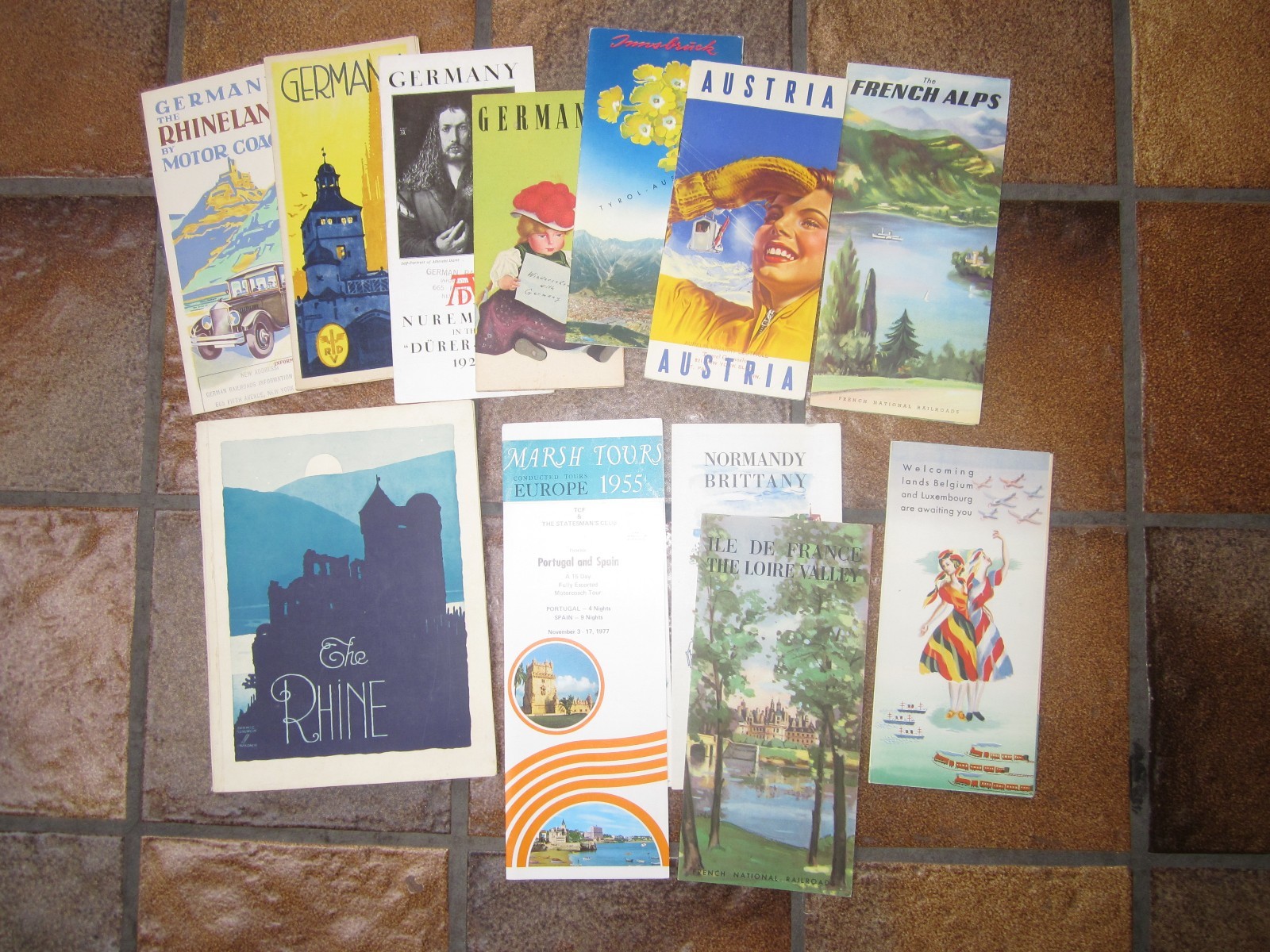 13 vintage European travel brochures.
