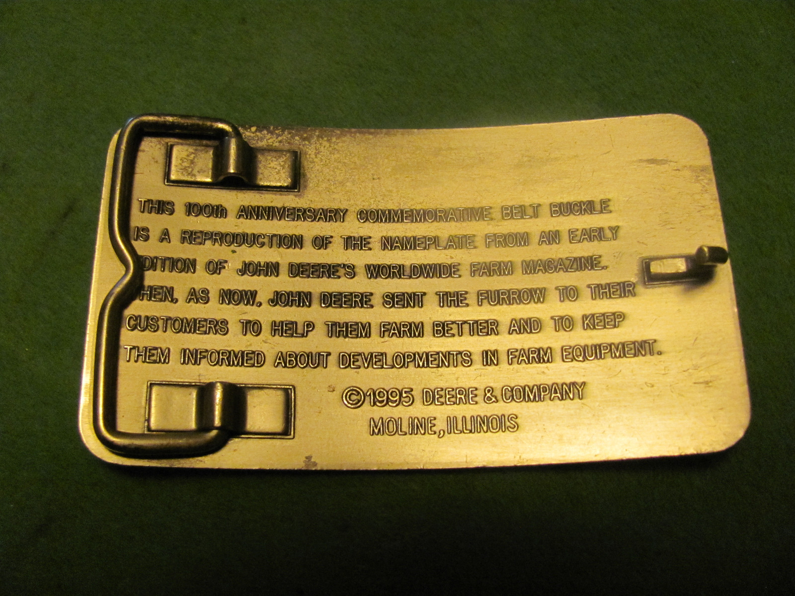 VINTAGE THE FURROW 1895-1995 100th ANNIVERSARY COMMEMORATIVE BELT BUCKLE.