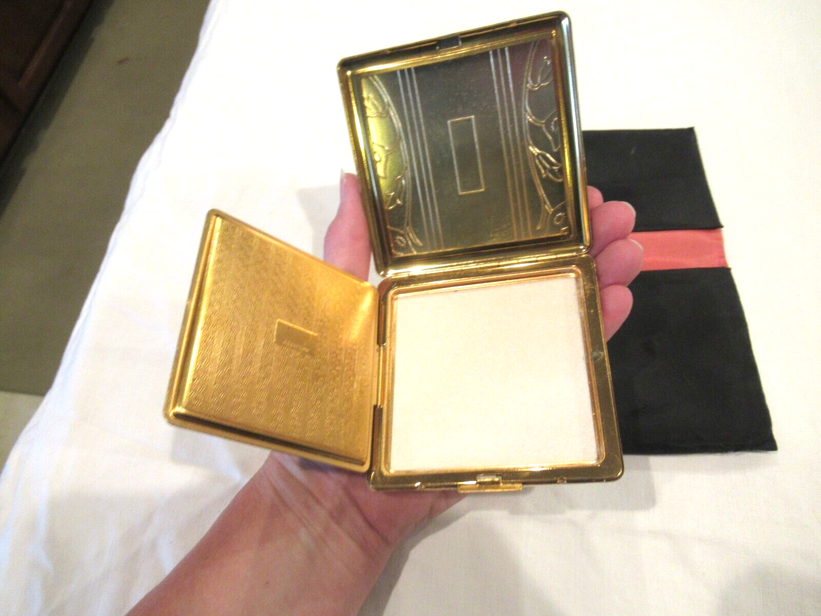 Vintage gold-colored metal compact, lilies, in black fabric case