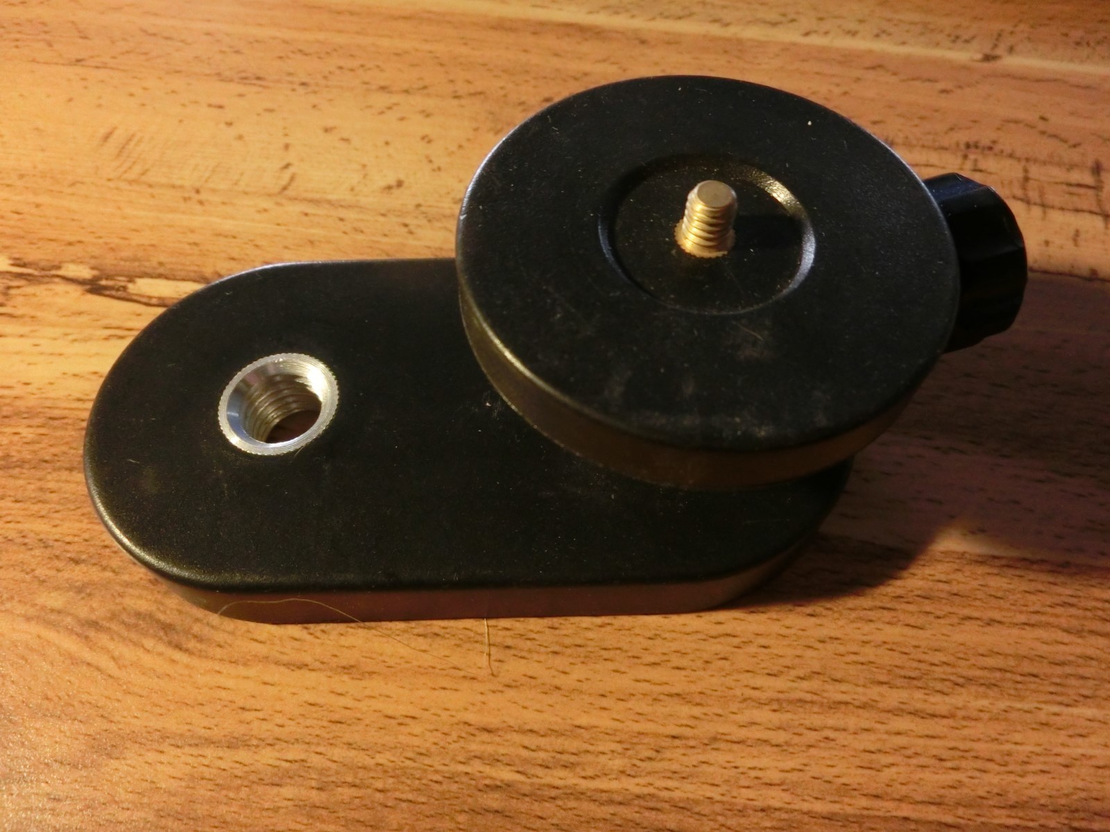 5/8-11 to 1/4-20 rotating platform with locking thumb screw. Mount on prism pole