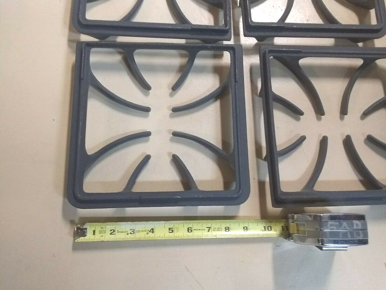 SET OF 4 BURNER GRATES BRAND NEW 9 1/4 INCHES X 9 INCHES (MAKER UNKNOWN)
