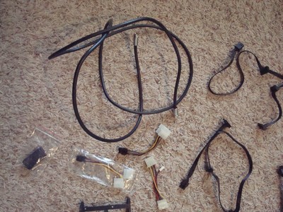 Lot of computer cables, cords, screws, and small parts