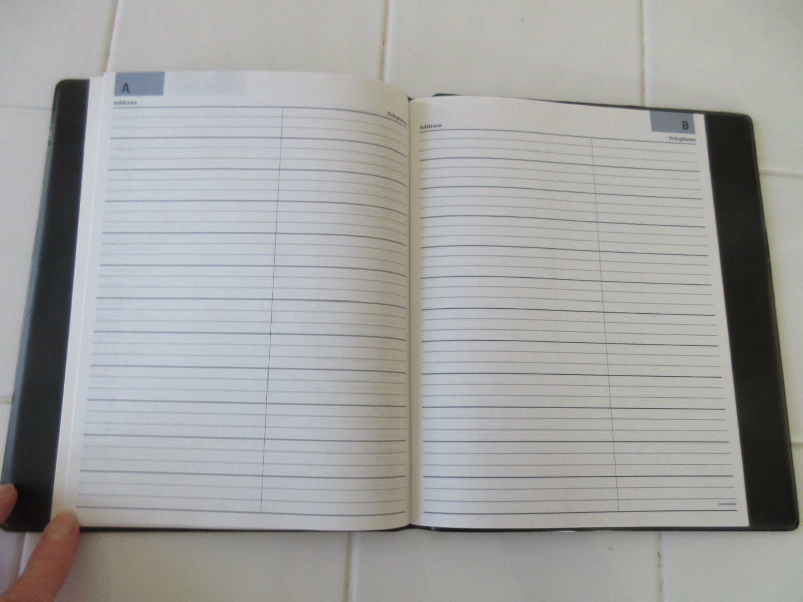 Address Book enclosed in Black Vinyl Folder.  9”x7.5”