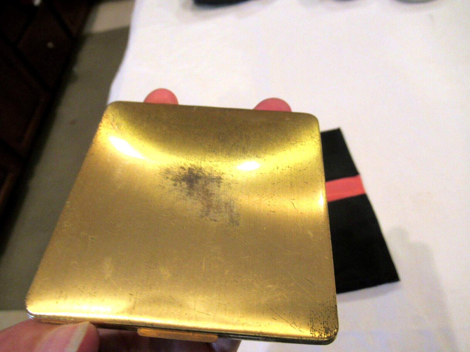 Vintage gold-colored metal compact, lilies, in black fabric case