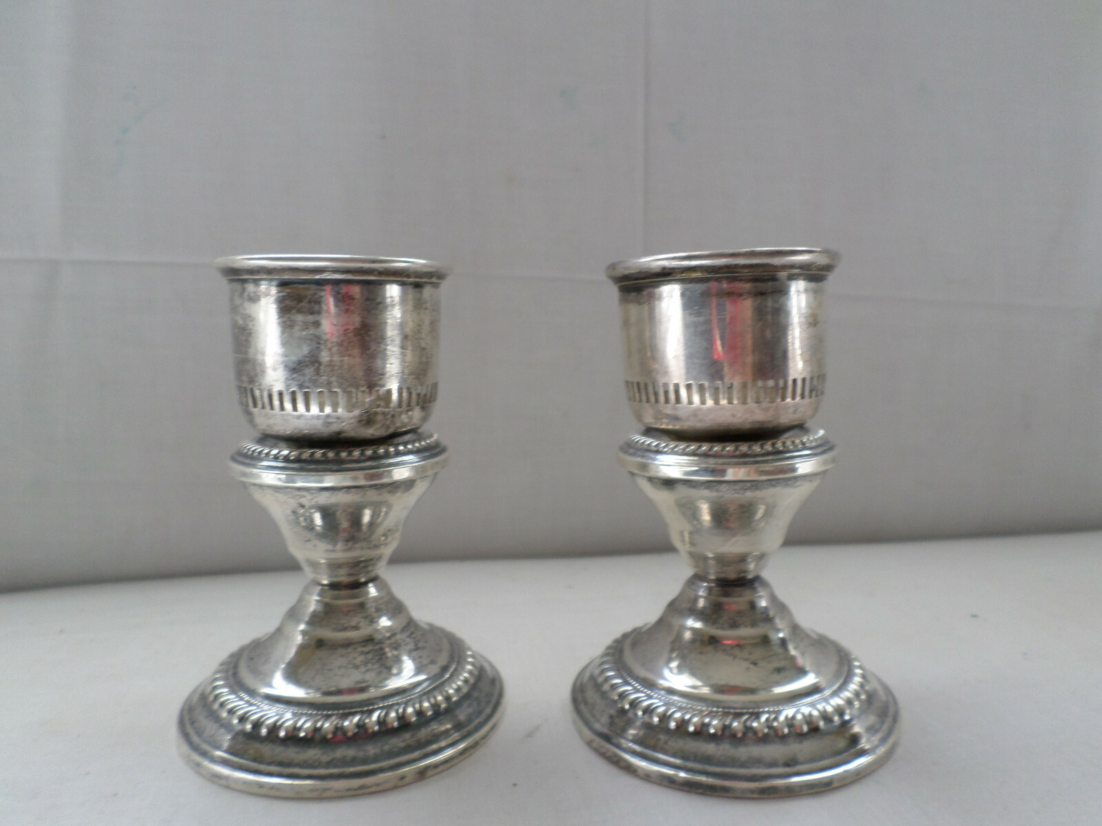STERLING SILVER PAIR OF CANDLESTICKS WITH STERLING HURRICANE SHADE HOLDERS