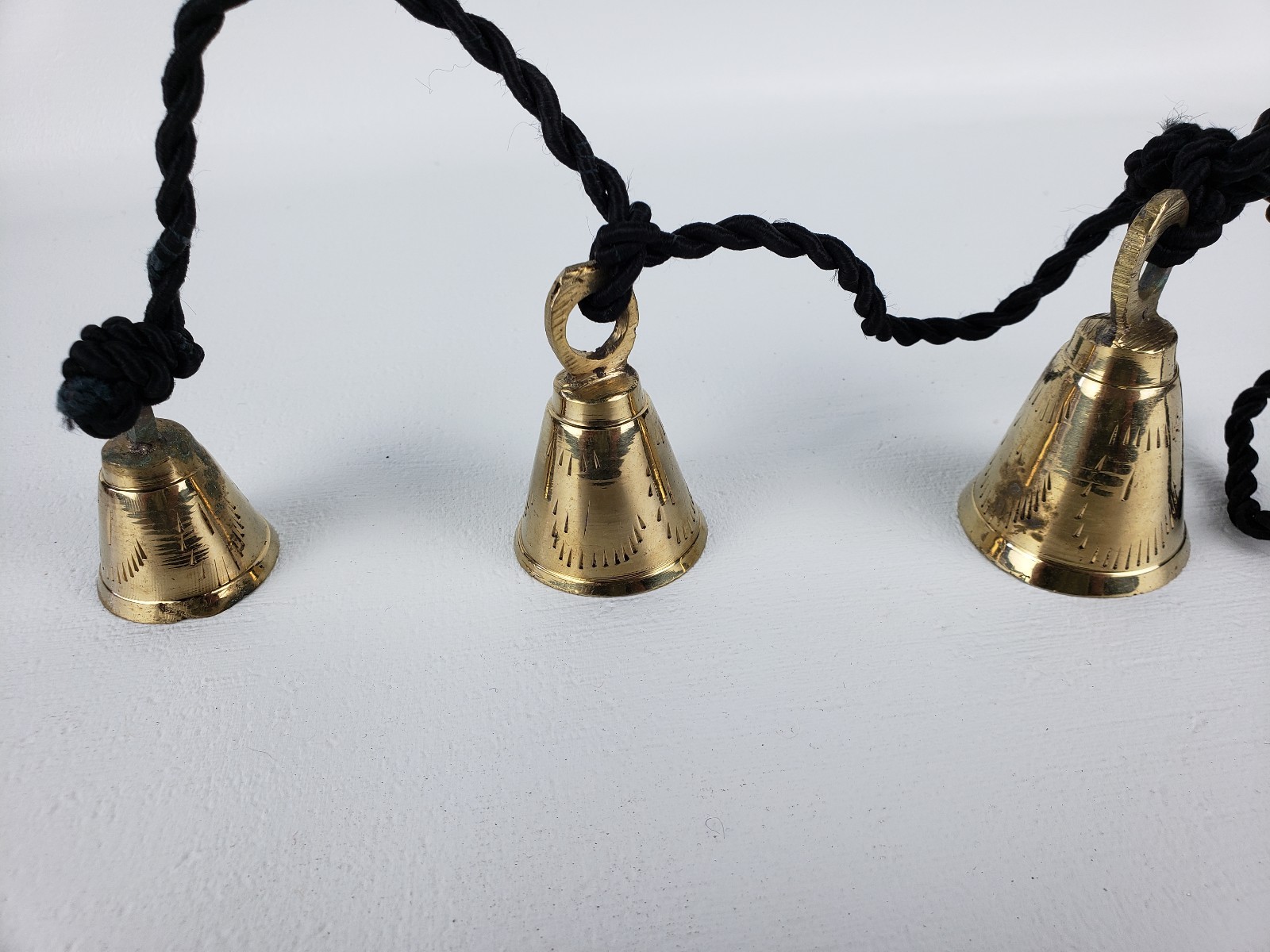 3 Brassy Bells Strung on a Black Rope India Same Shape Different Sizes