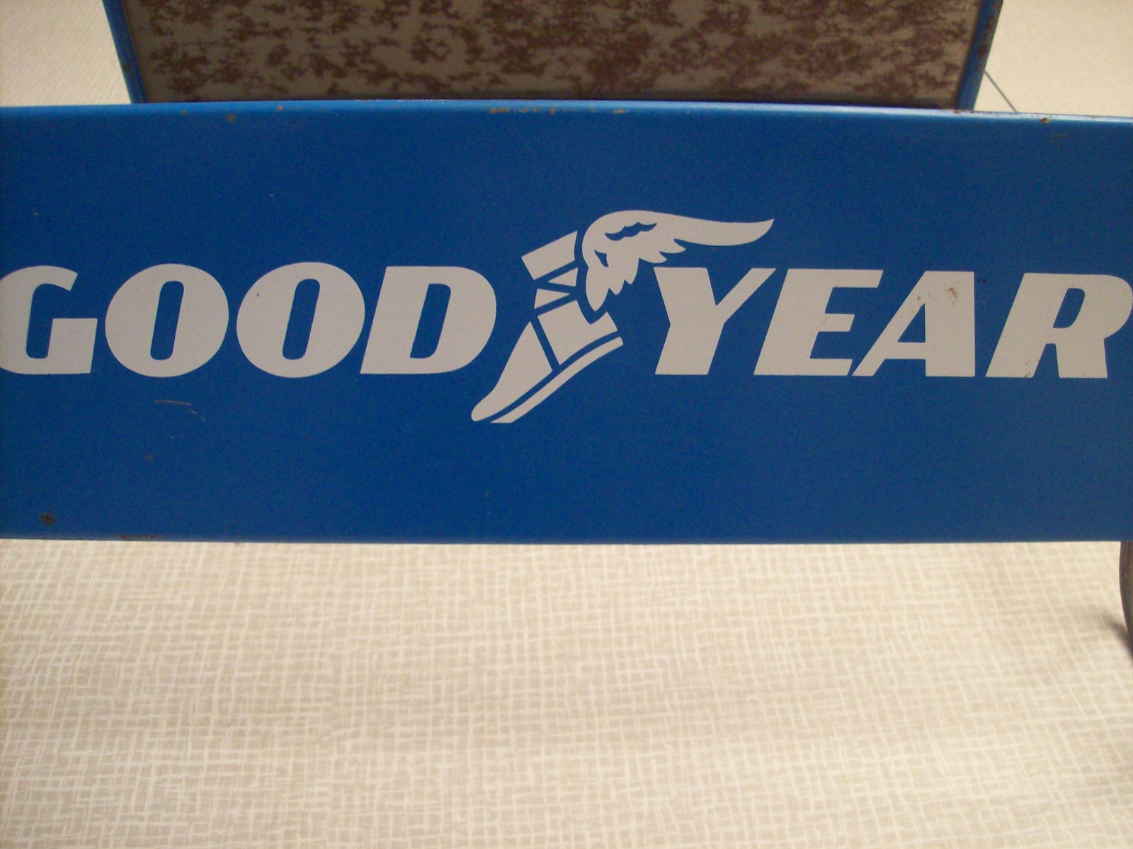 Goodyear tire stand, wing foot, vintage tire shop advertising