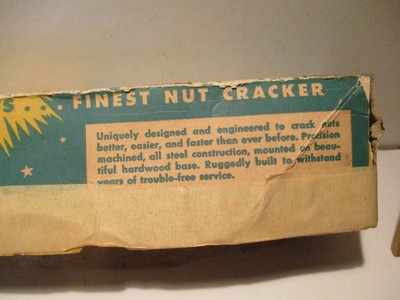 VINTAGE REEDS ROCKET  NUT CRACKER IN ORIGINAL BOX. BOX IS IN POOR CONDITION.