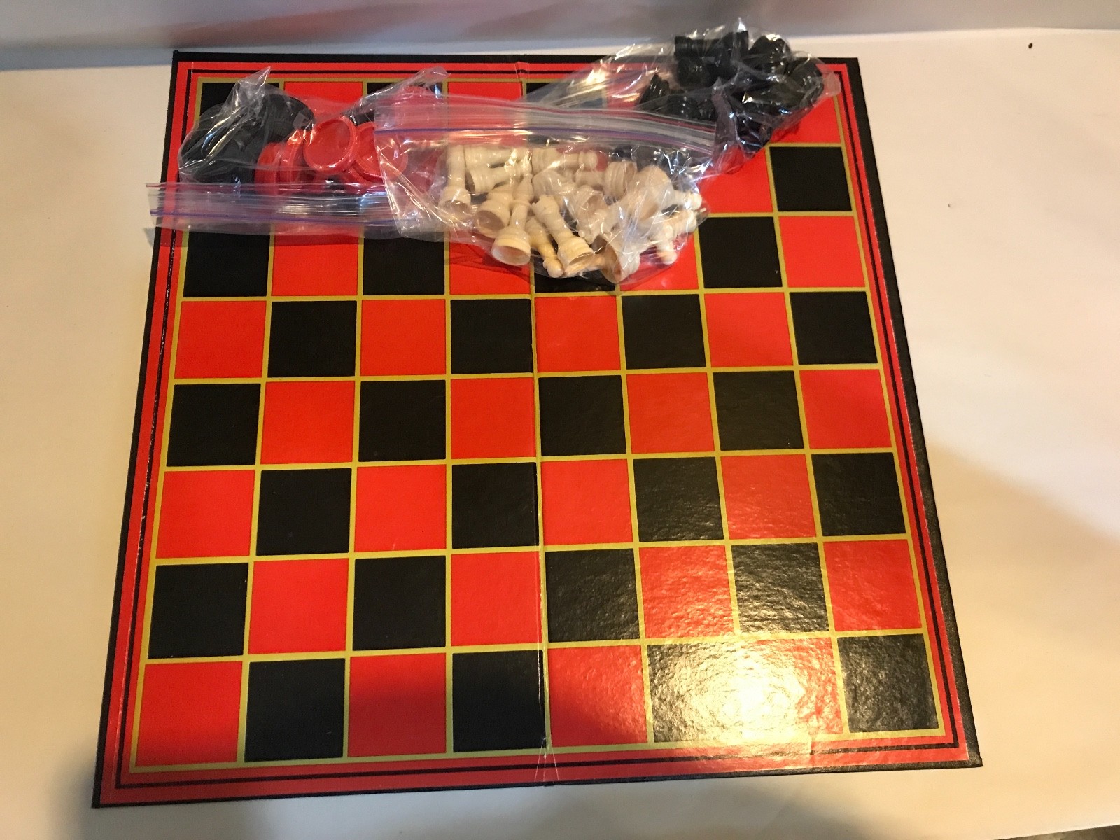 PRESSMAN FOLDING CHESS BOARD W/ CHESS AND CHECKERS PIECES.