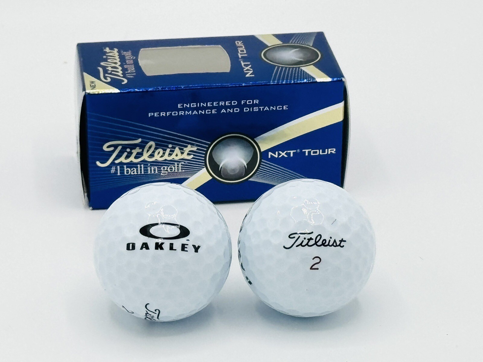 NEW SET OF 2 OAKLEY GOLF BALLS TITLEIST NXT TOUR LIMITED