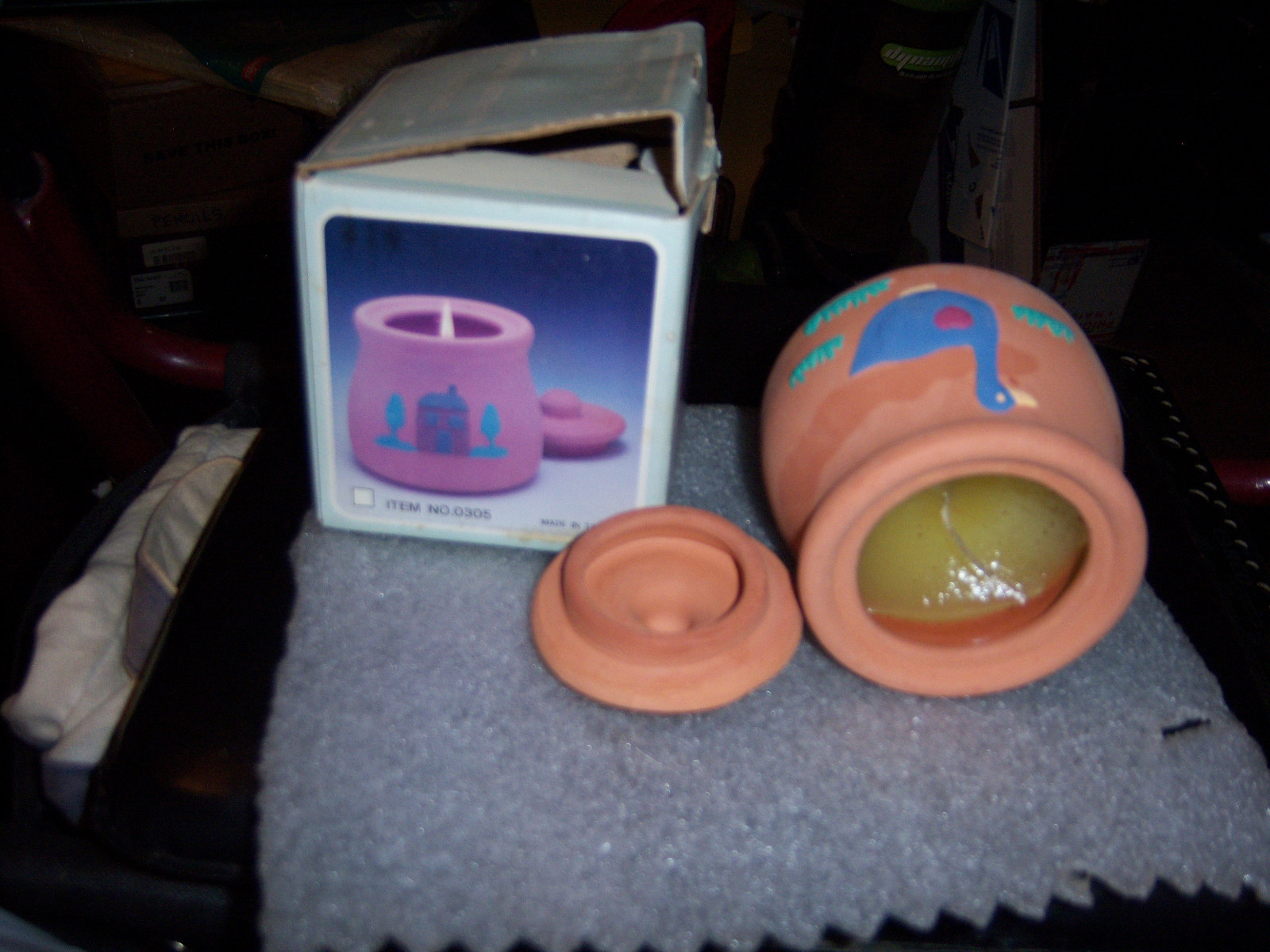 Terra cotta candle pot filled with wax.  Container measures 3” tall 2” round lis