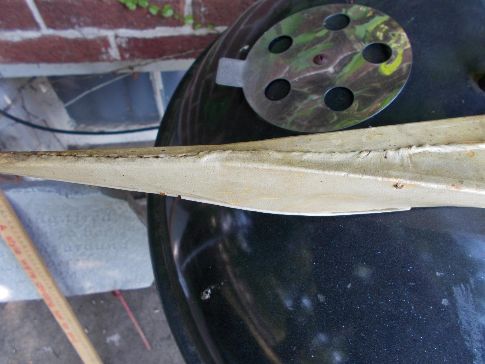 VERY OLD ESKIMO FOLK ART KAYAK WITH DOLL-SEAL SKIN AND WOOD 27.5 INCHES