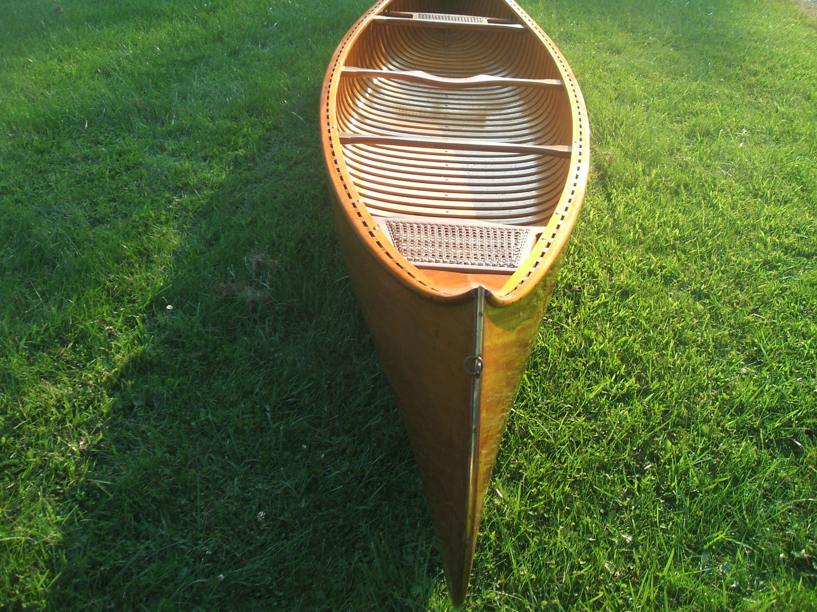 Handcrafted 17' Cedar rib wooden canoe with hand woven seats and brass trim