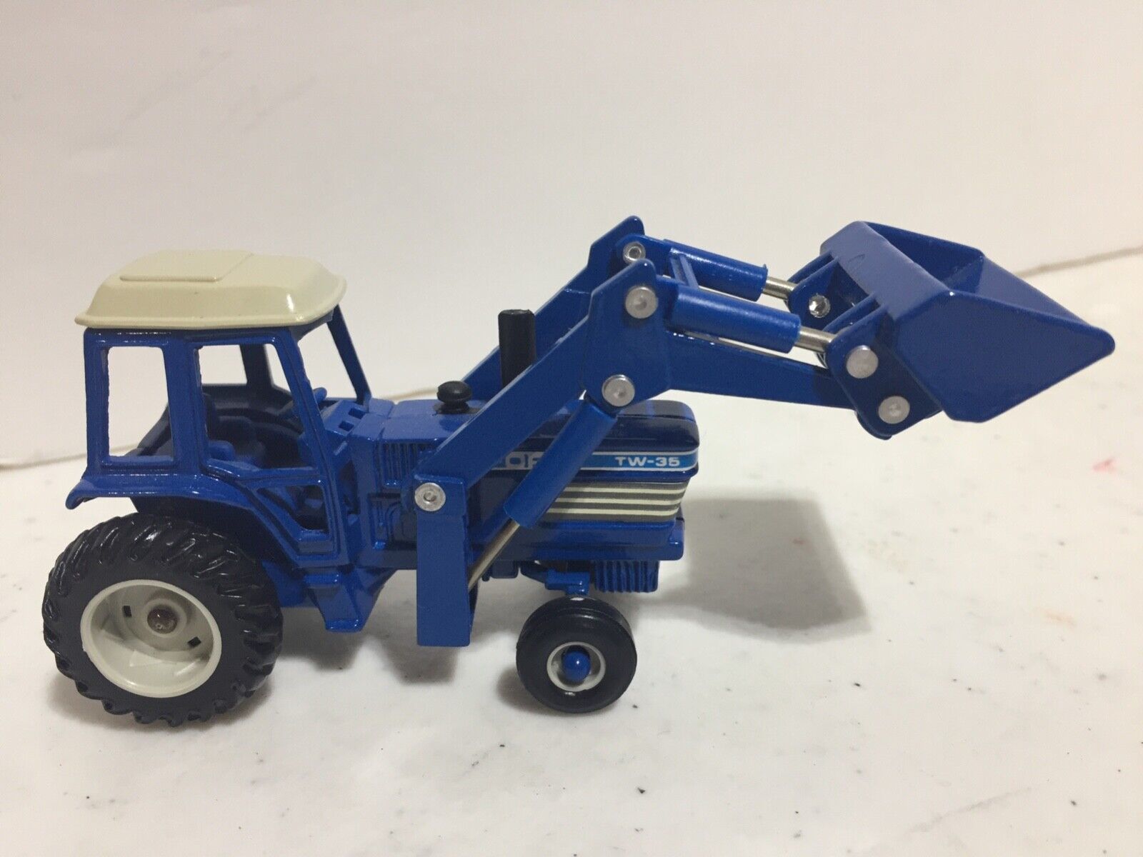 Ford TW-35 Tractor w Front Loader & Cab Slightly Used 1/64 Scale by Ertl Ford TW-35 Tractor w Front Loader & Cab Slightly Used 1/64 Scale by Ertl