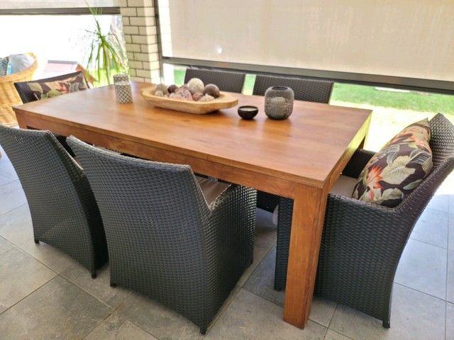 Stunning outdoor teak dining setting with wicker armchairs | Outdoor