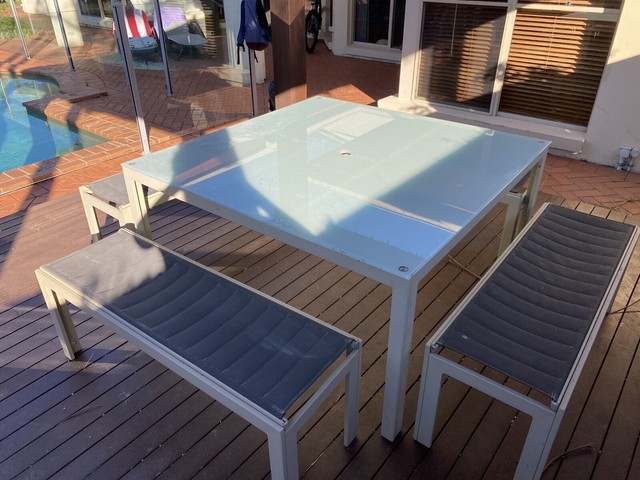 Outdoor setting with big square table and 4 benches ...