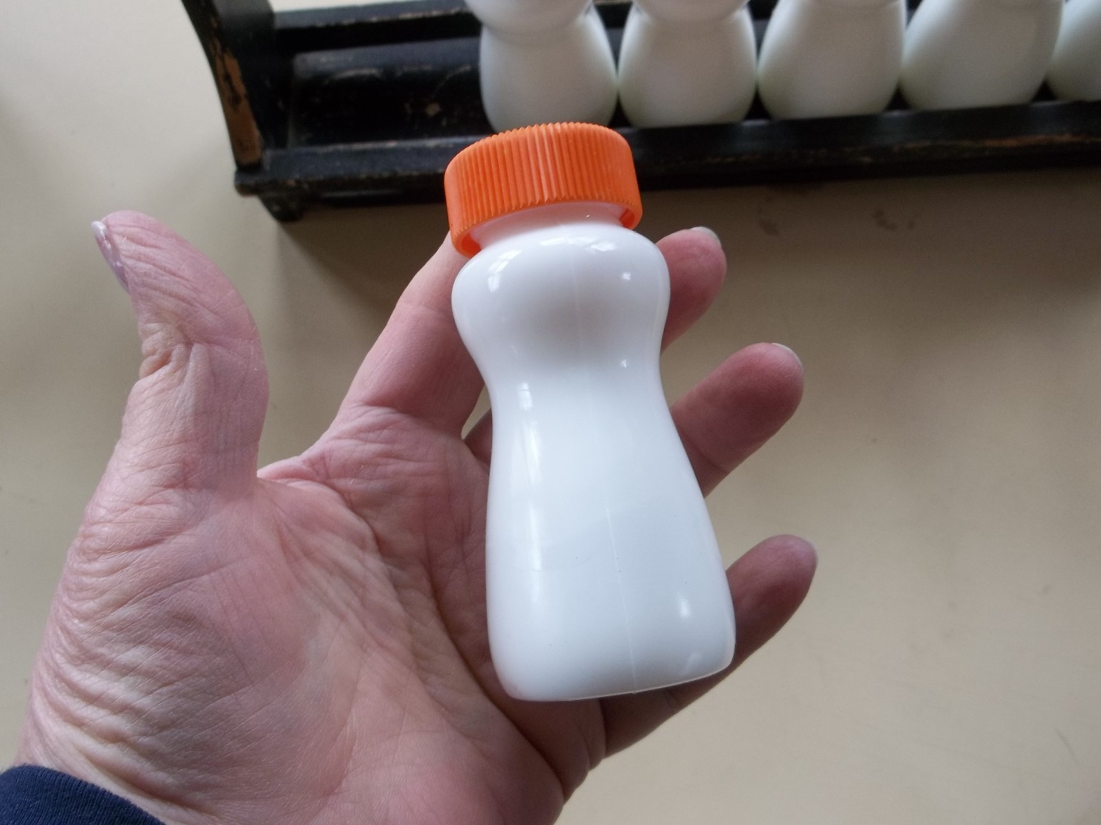 Vintage Glass Bottles with Colorful Tops Distressed Wooden Rack for Spices