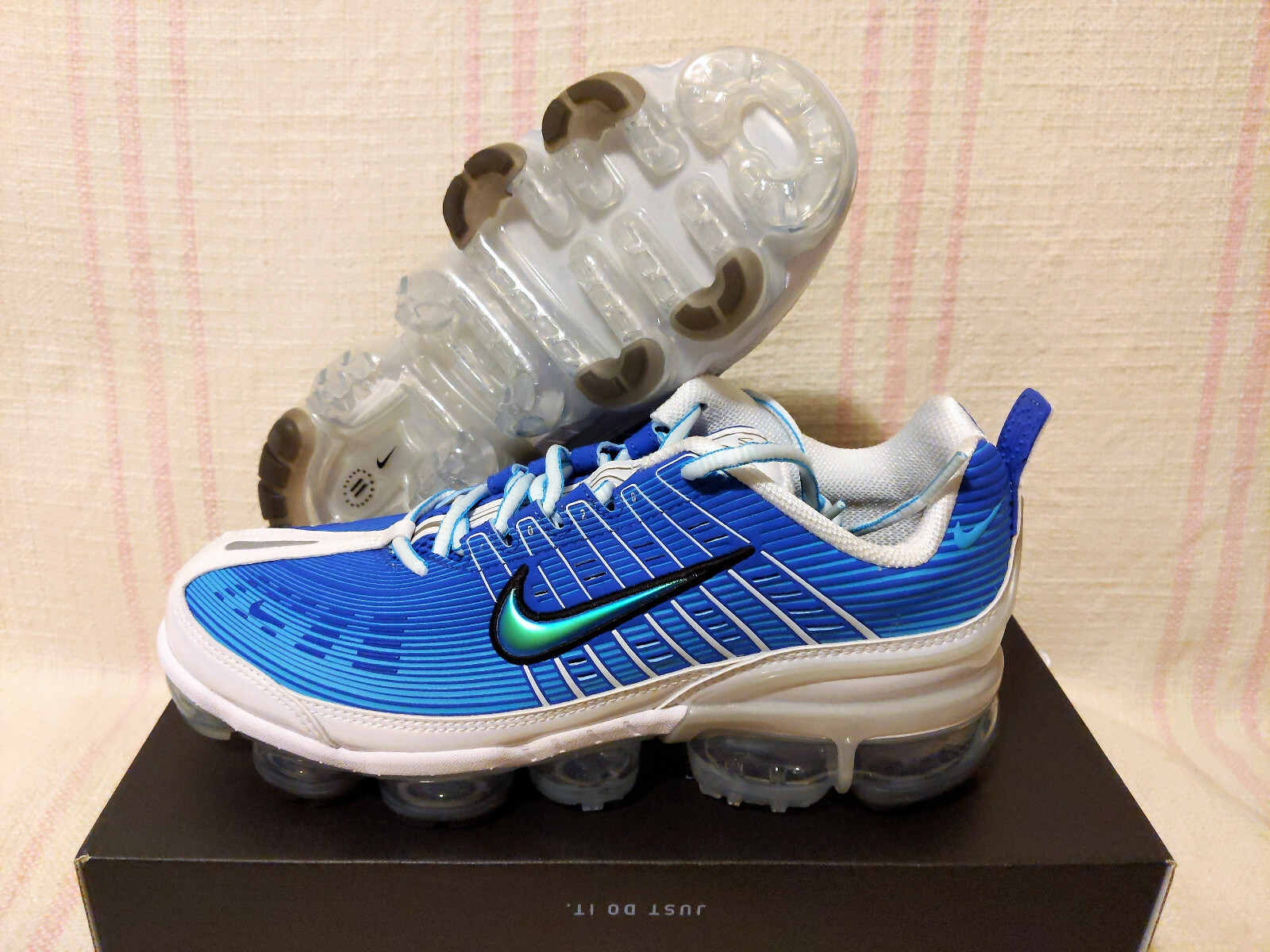 white and blue vapormax 360