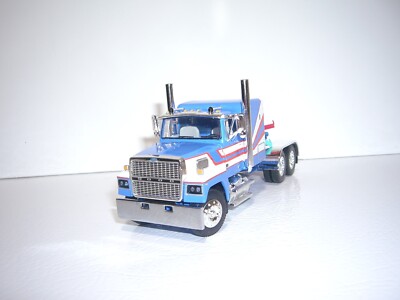 DCP FIRST GEAR 1/64 BLUE W/T WHITE & RED STRIPES FORD LTL 9000 W/T 60'' SLEEPER