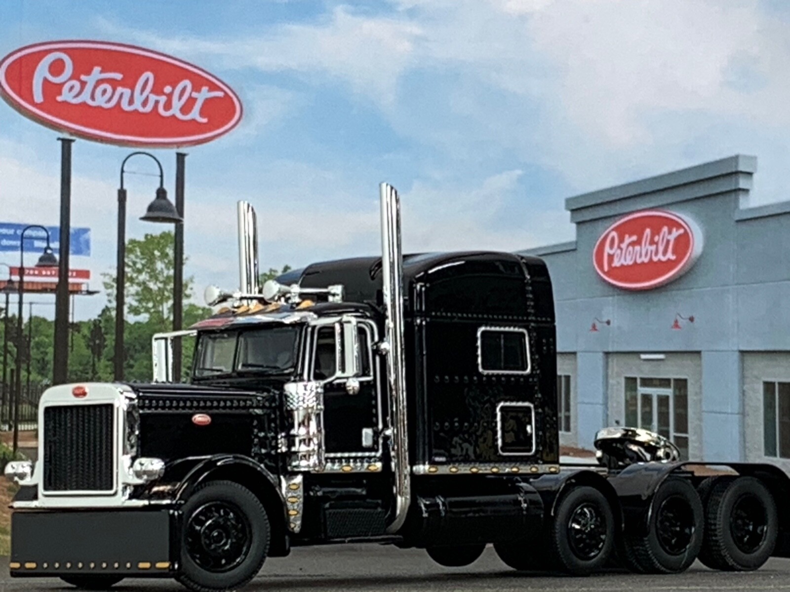1/64 DCP BLACK PETERBILT 389 TRI AXLE W/ 70