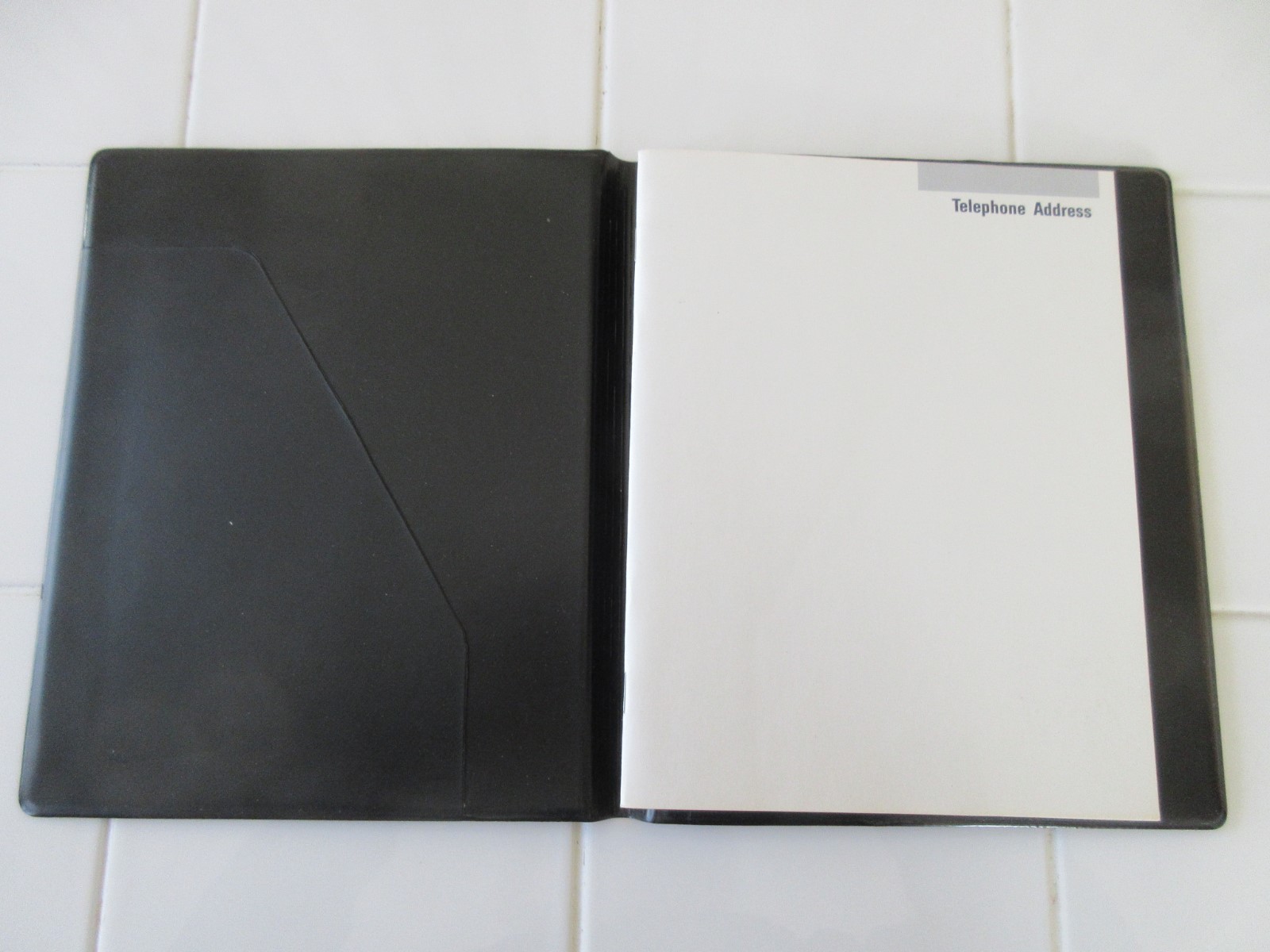 Address Book enclosed in Black Vinyl Folder.  9”x7.5”