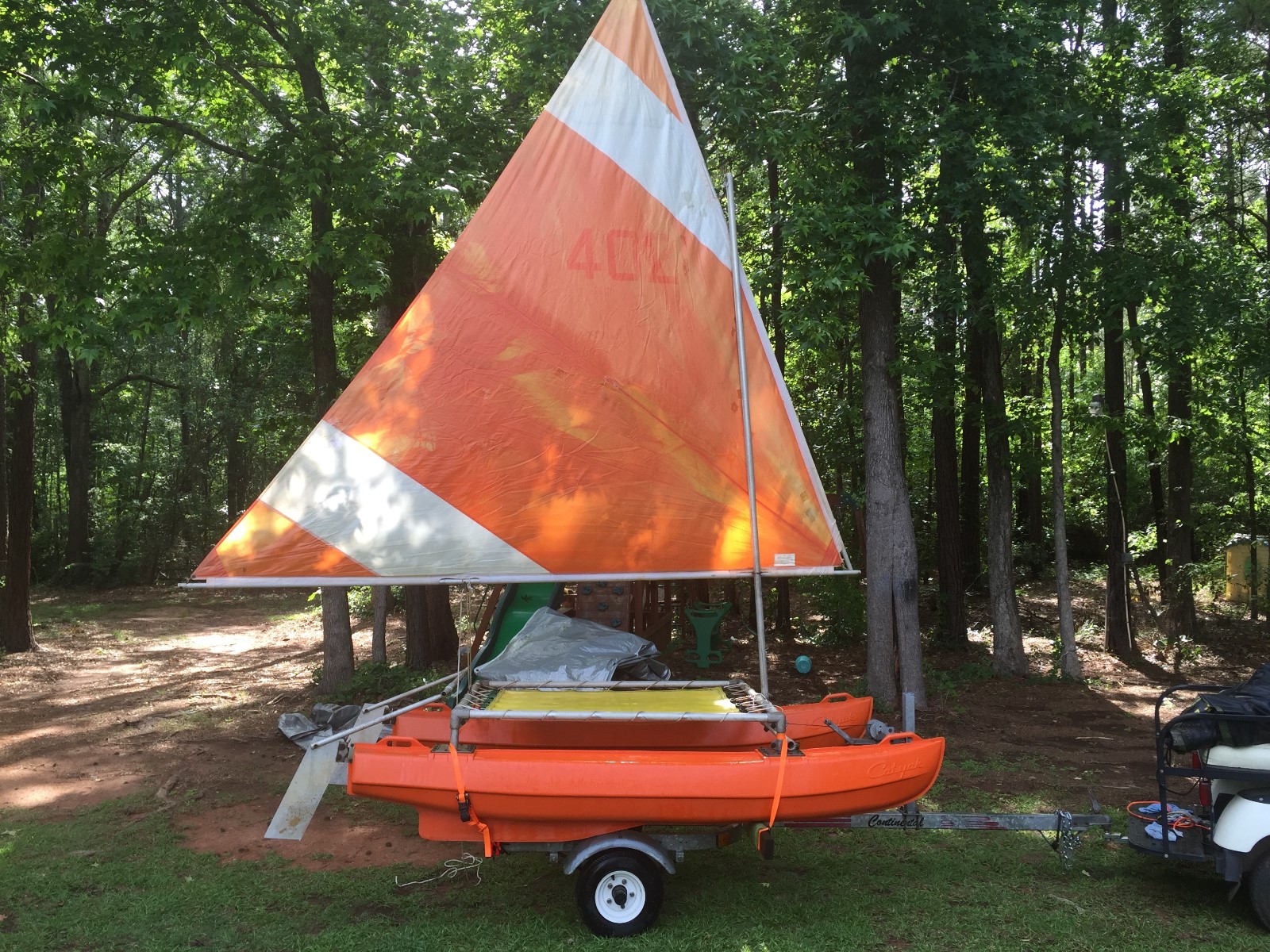 vintage catyak sailboat and trailer