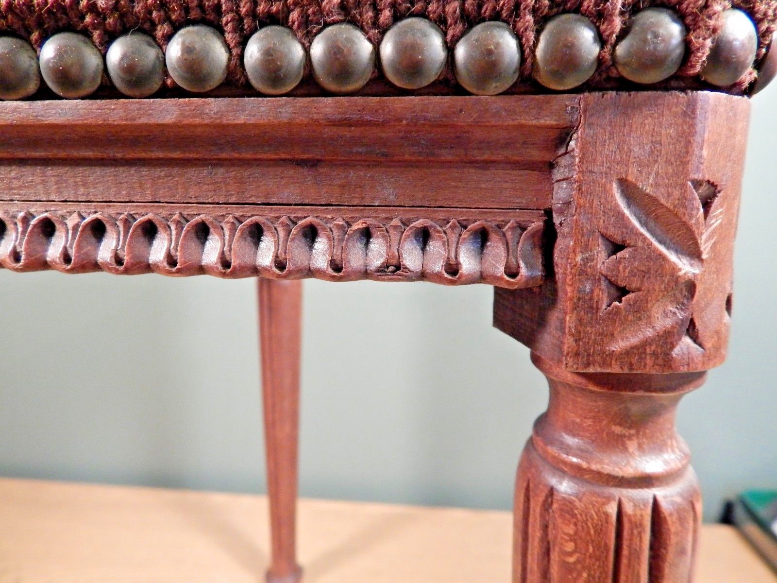 ANTIQUE FRENCH UNUSUAL TRIANGULAR CARVED FOOTSTOOL WITH OLD NEEDLEPOINT COVER