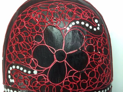 intricately-detailed red wooden african mask.
