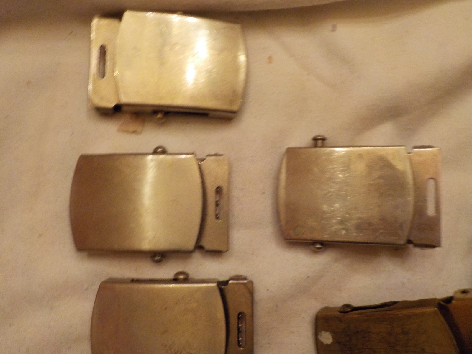 LOT OF ASSORTED MILITARY BELT BUCKLES AND  ONE BELT