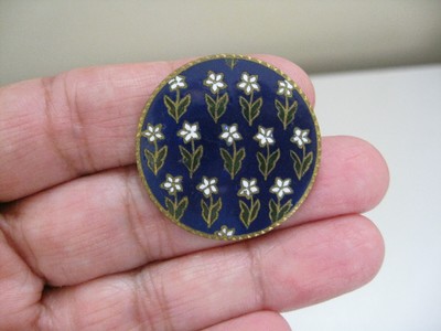 1 cupid button in painted enamels 1 and a half inch by 2 inch.