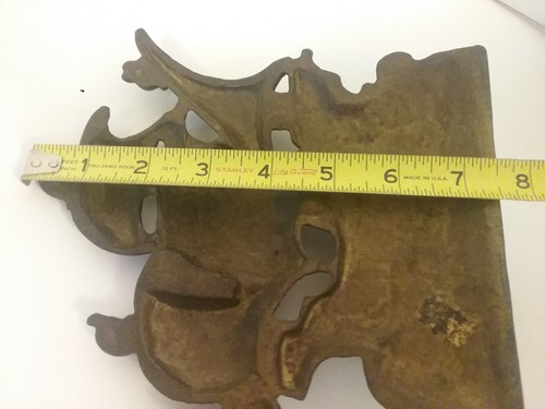 A CAST METAL SHIP ON THE WATER DOORSTOP