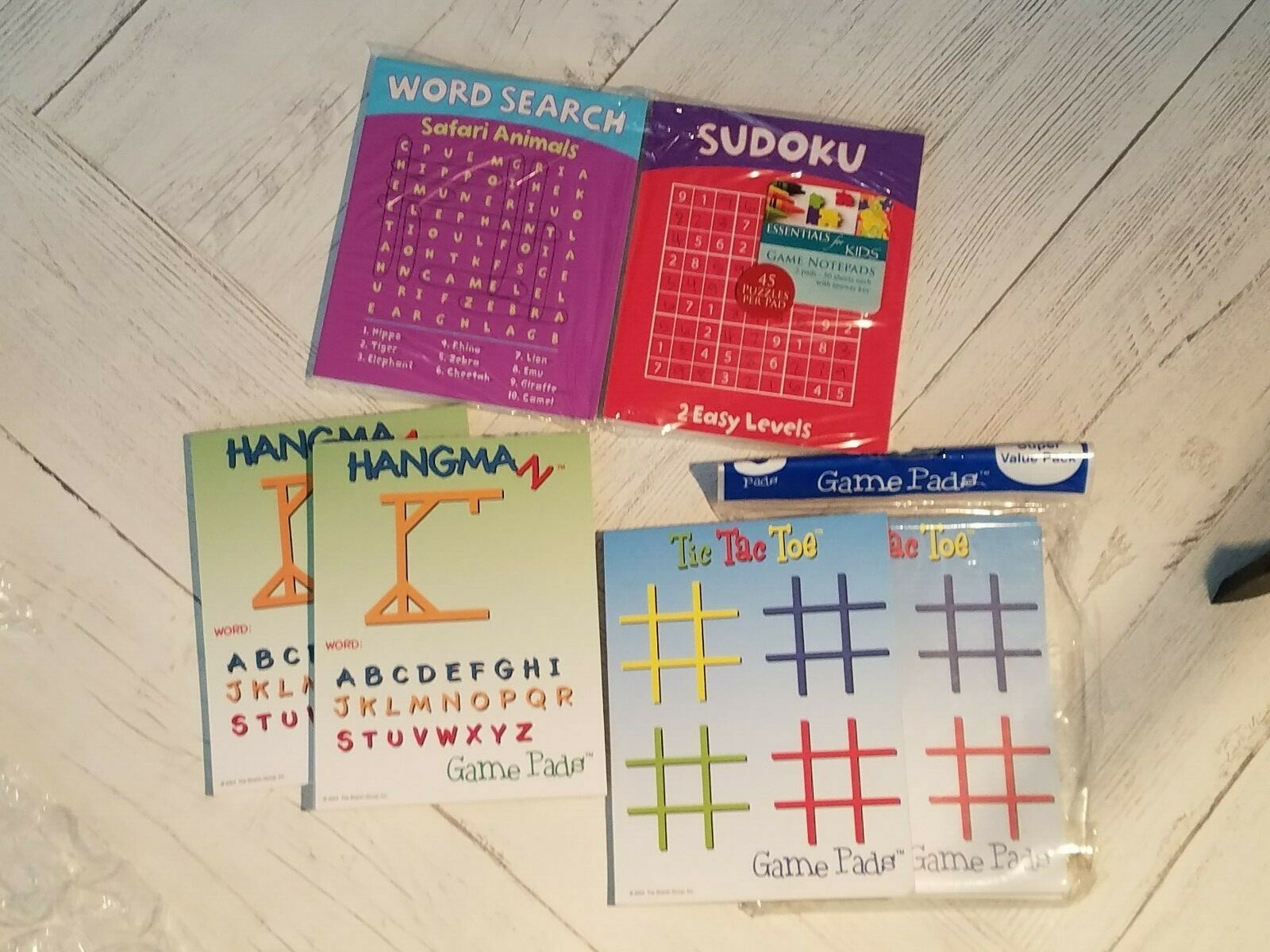 7  Multicolored Game Pads Sudoku(1) Word Search(1) Hangman(2) Tic Tac Toe(3)