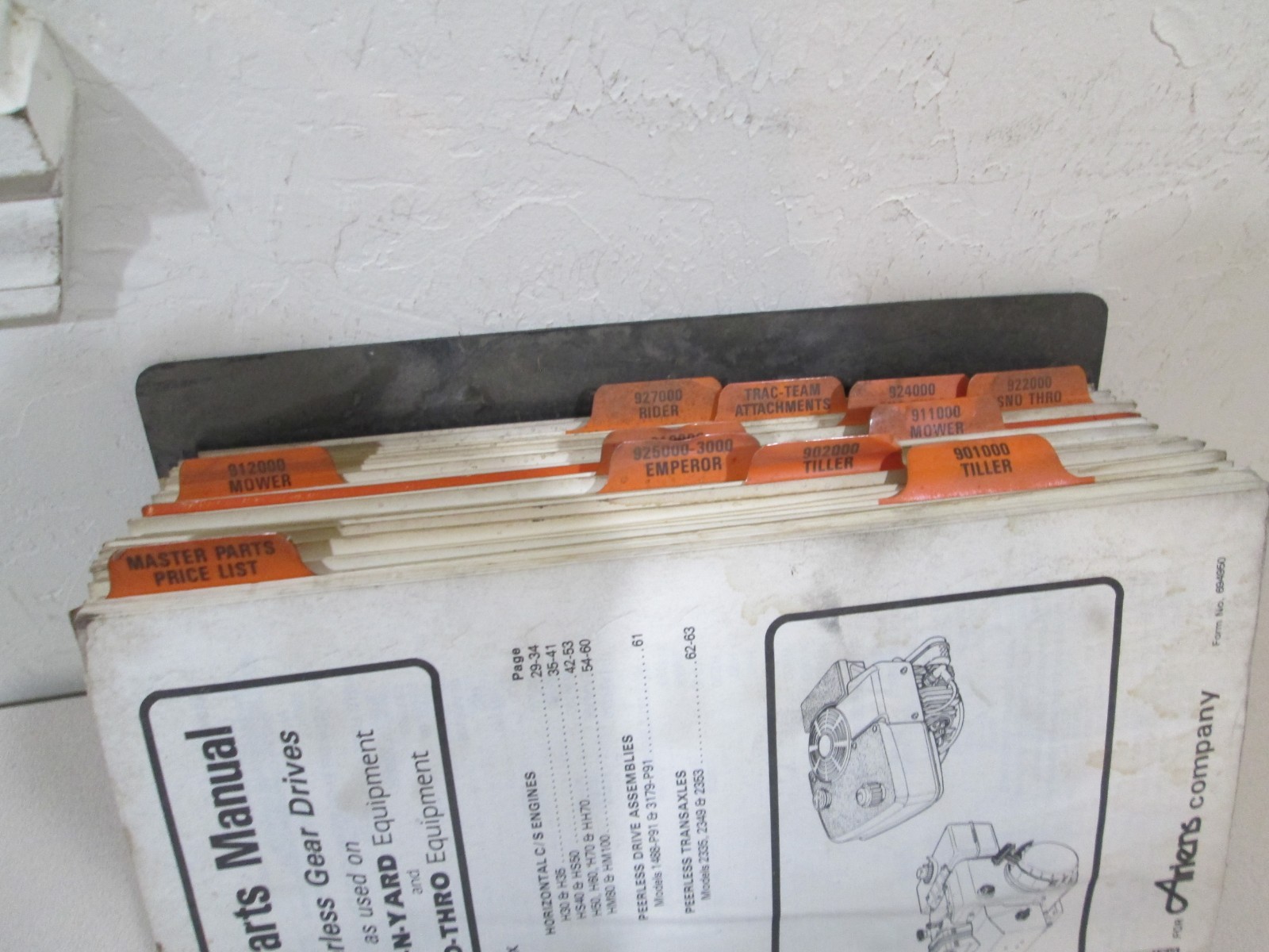 Binder full of Ariens Parts Manuals