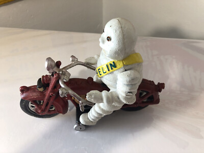 Michelin Man Bibendum on Red Motorcycle Cast Iron Toy