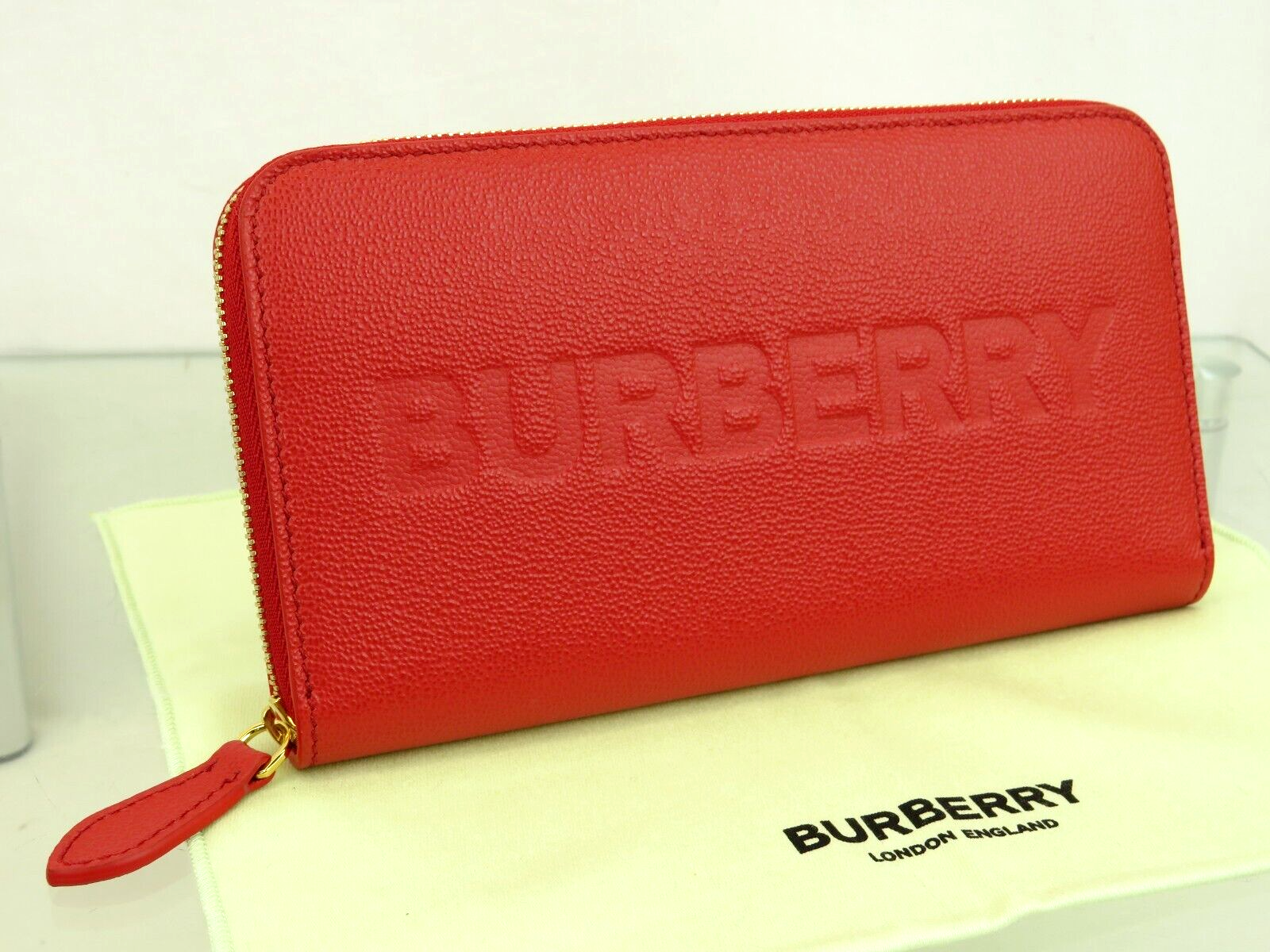 BURBERRY ELMORE RED LOGO EMBOSSED LEATHER ZIP AROUND CLUTCH