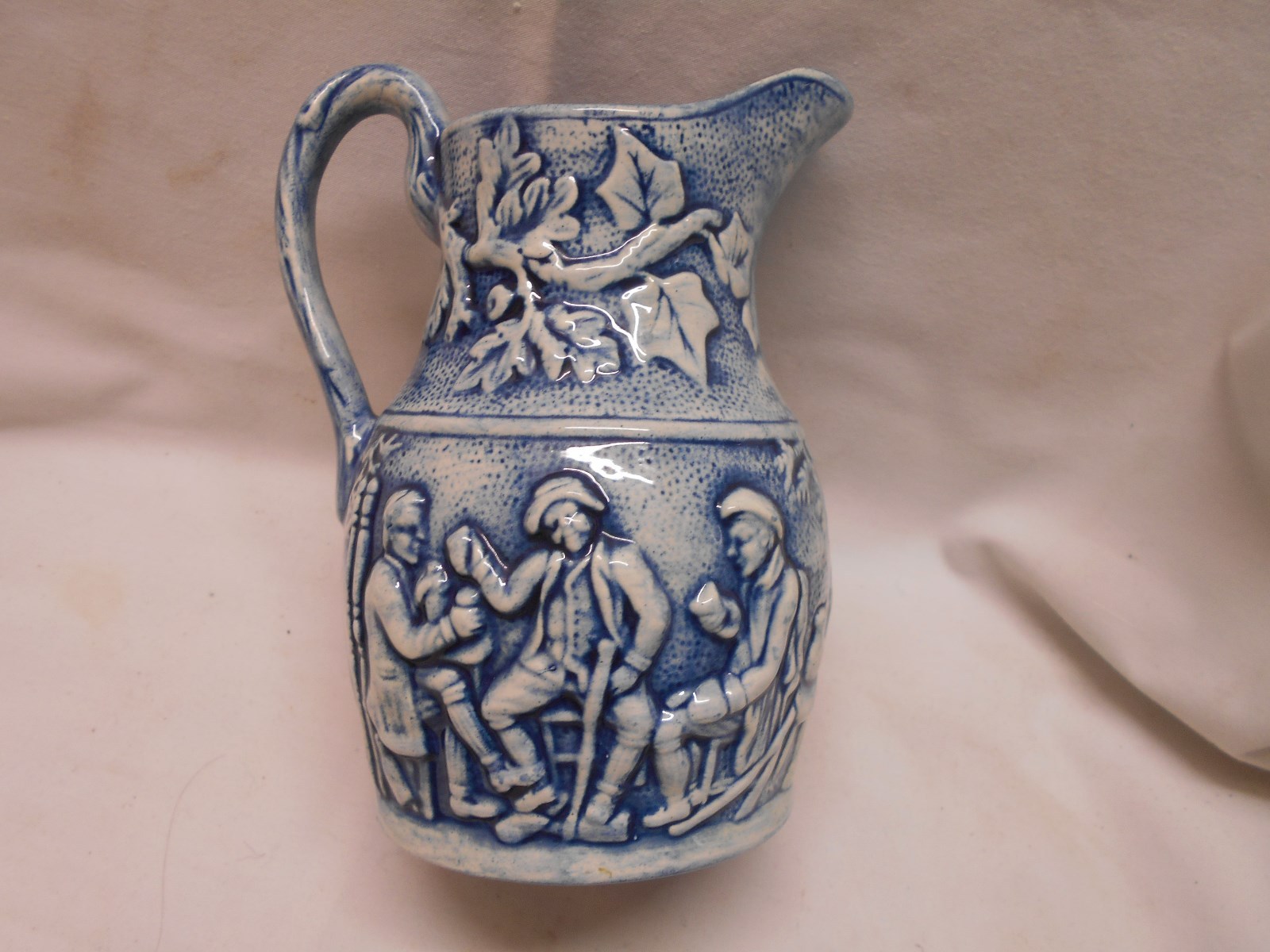 Vintage blue and white water pitcher vintage men drinking beer embossed