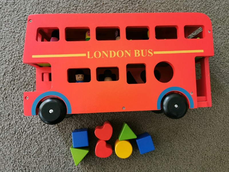 wooden london bus with passengers