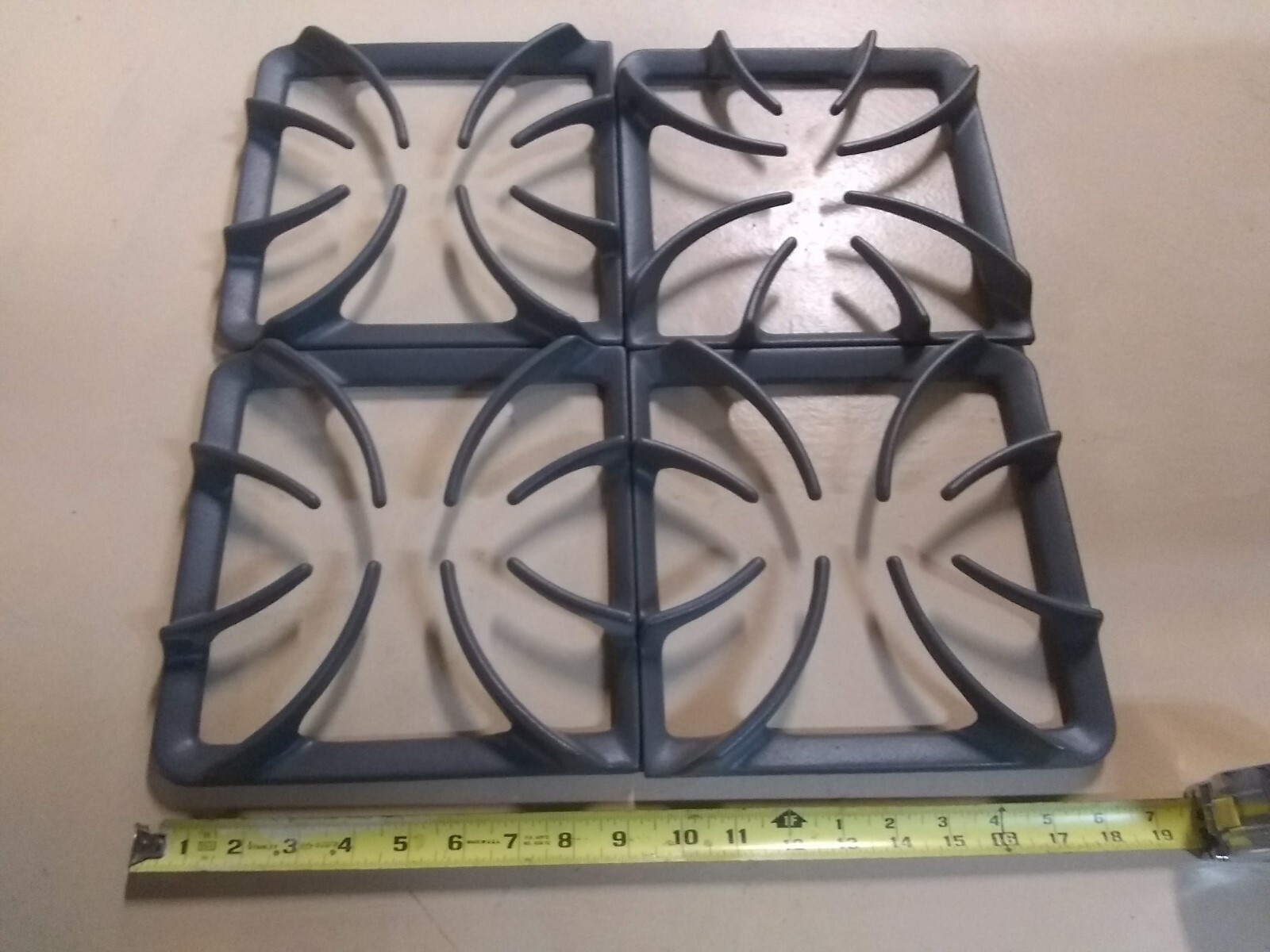 SET OF 4 BURNER GRATES BRAND NEW 9 1/4 INCHES X 9 INCHES (MAKER UNKNOWN)