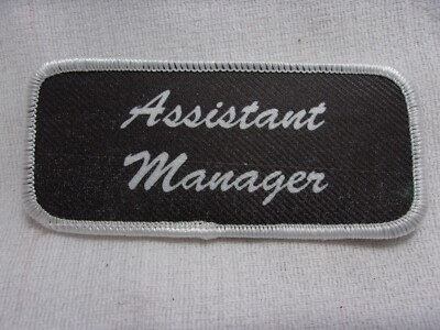 ASSISTANT MANAGER  USED SILK SCREEN  SEW ON NAME PATCH TAGS WHITE ON GREY