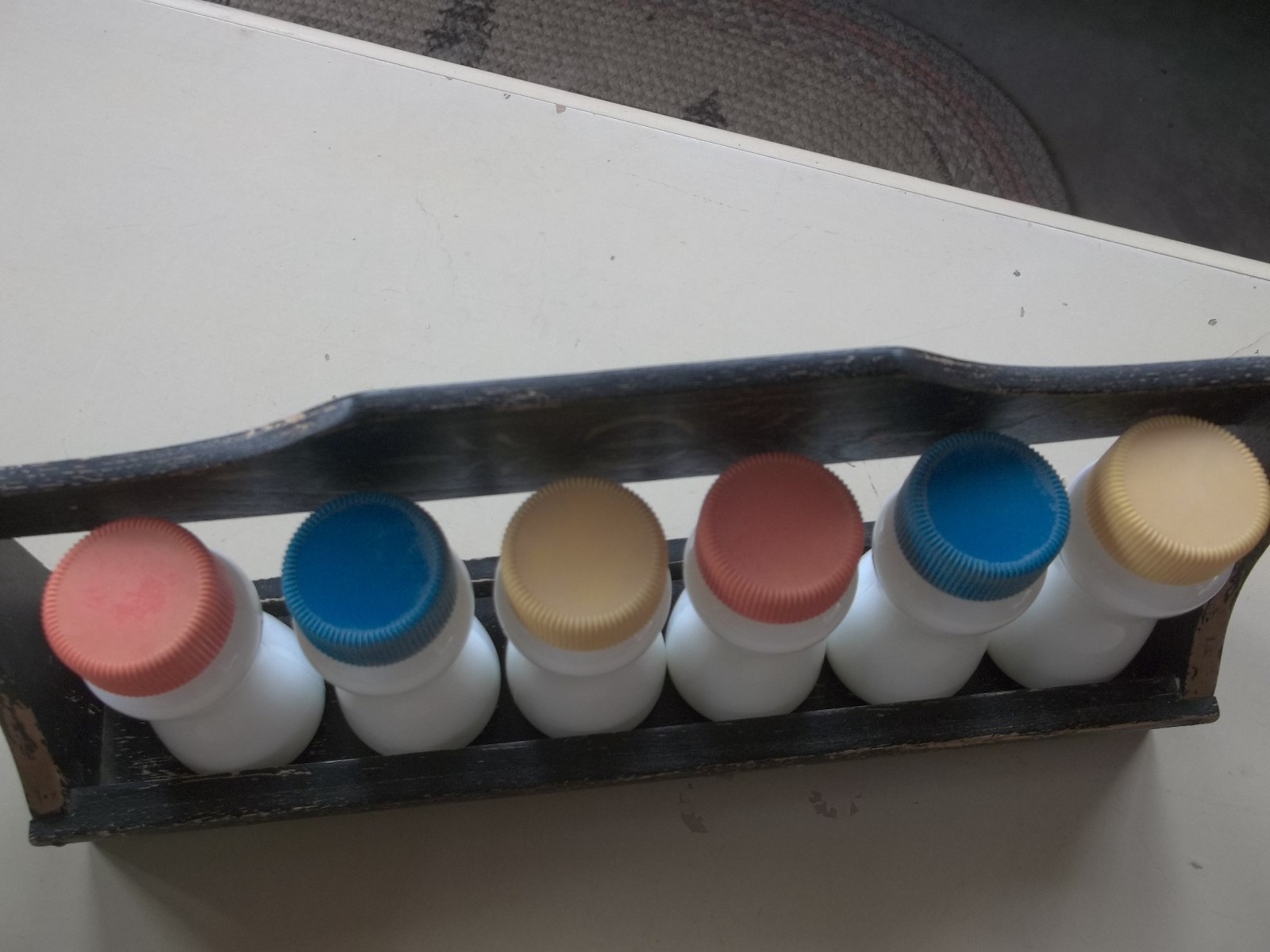 Vintage Glass Bottles with Colorful Tops Distressed Wooden Rack for Spices