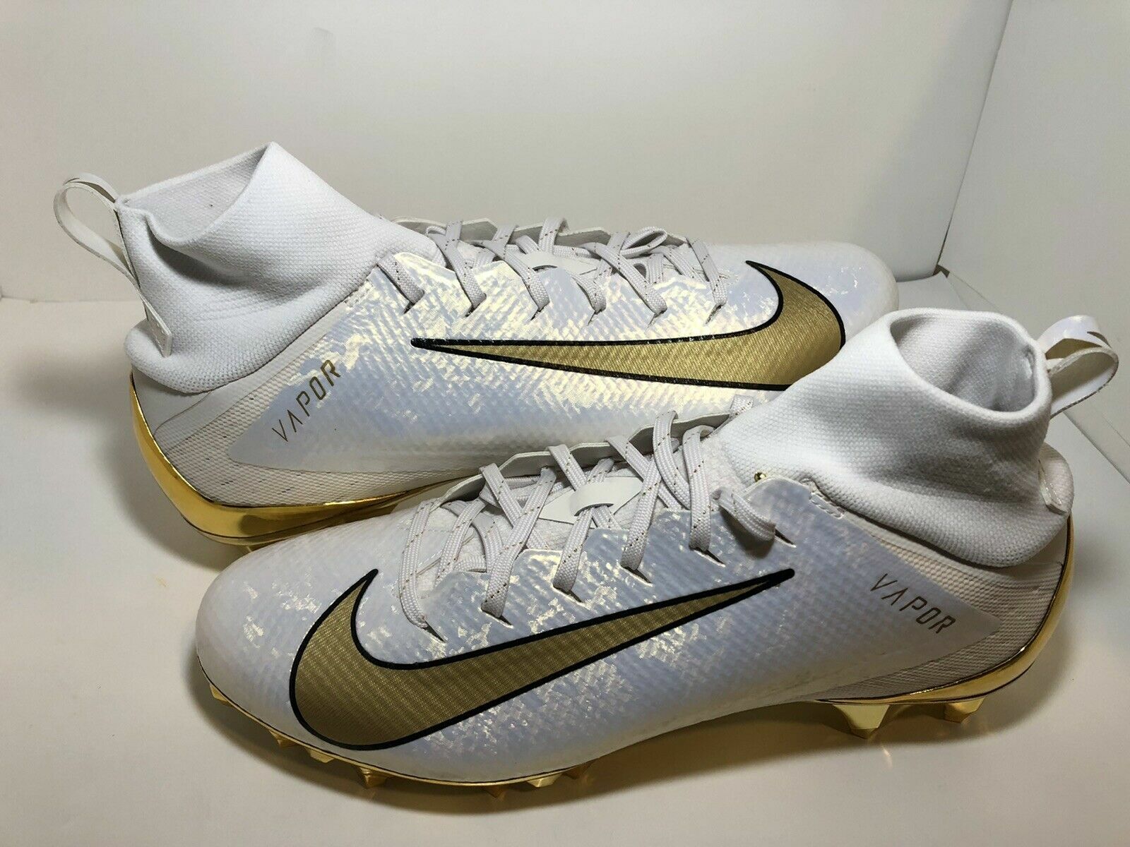 gold and white nike football cleats