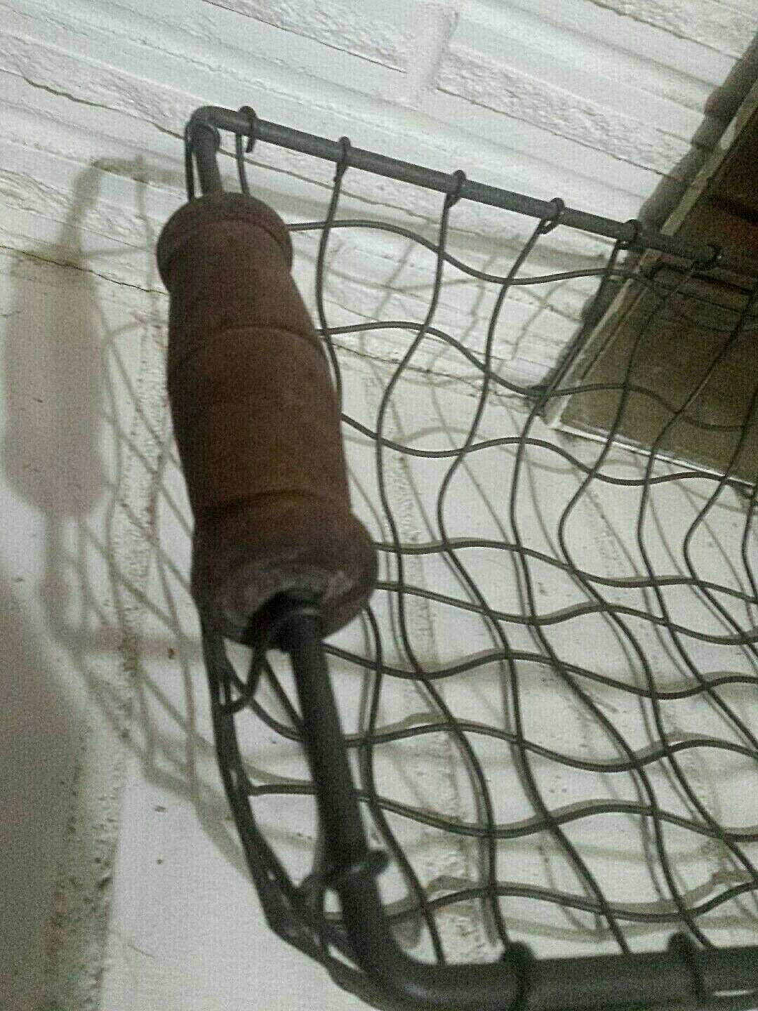 OLD FACTORY? METAL STURDY BASKET, WITH WOOD HANDLE.  VERY UNIQUE WIRE CURVES..