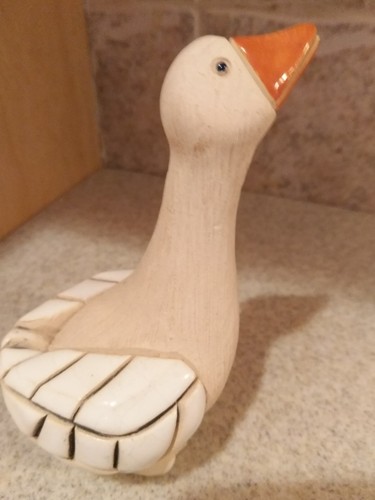 hand carved wooden goose with marble wings and ceramic beak. 5'' tall x 4'' wide
