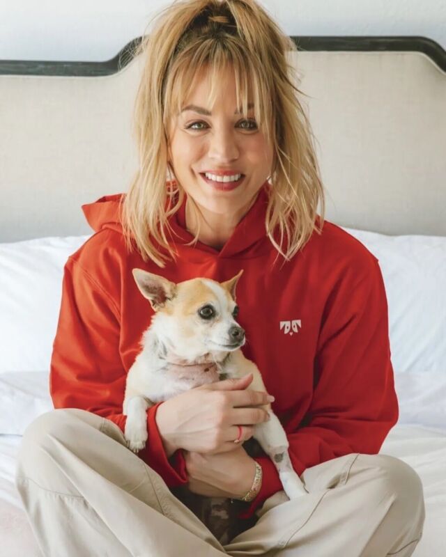 Kaley Cuoco Smiling Carrying Dog 8x10 Photo Print