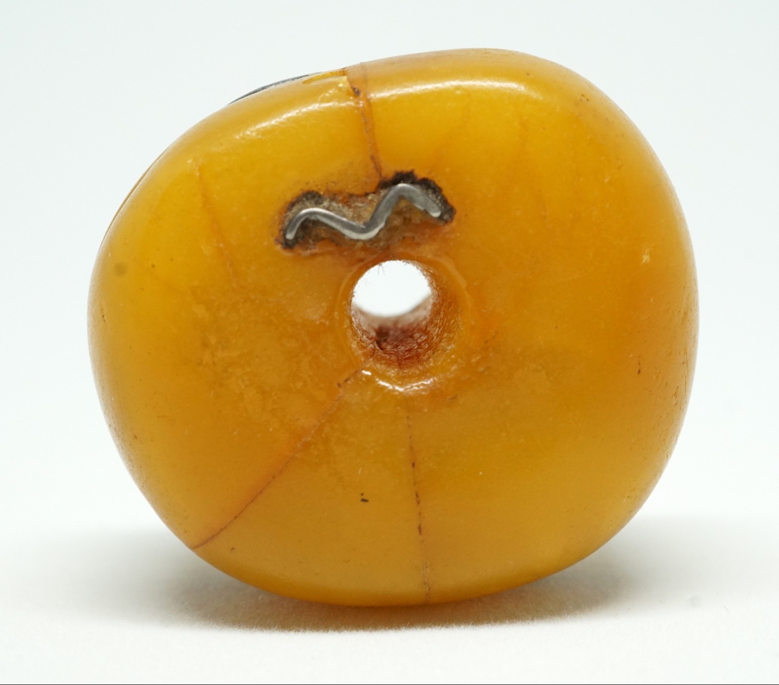 A Large Antique Amber Bead from the Sahara, with Silver Repairs